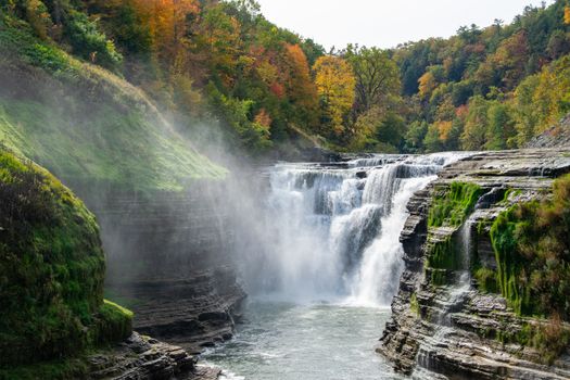 Stunning view of Letchworth State Park waterfall surrounded by fall foliage, showcasing the beauty of nature.