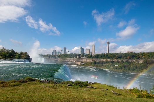 Capture the breathtaking beauty of Niagara Falls with a vibrant rainbow in the foreground.