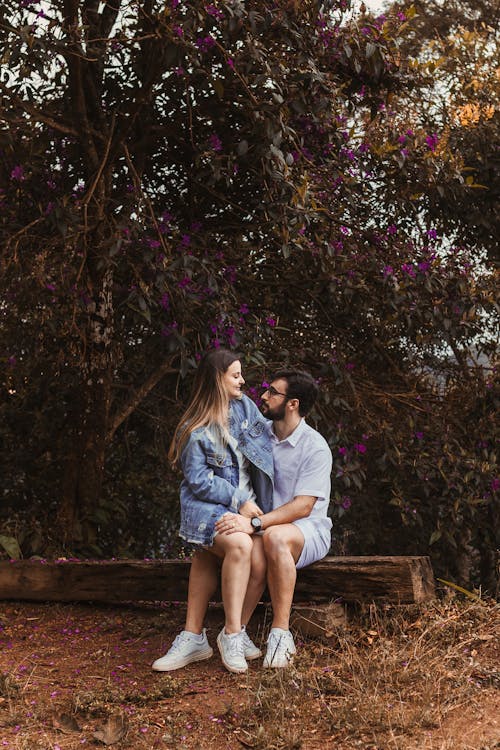 Loving Couple Sitting Together on Wooden Bench