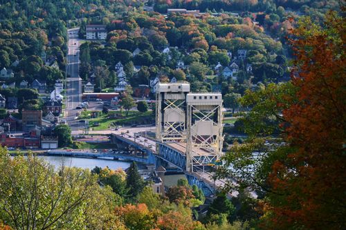 Free Aerial view of Portage Canal Lift Bridge amidst fall foliage in Michigan's Upper Peninsula. Stock Photo