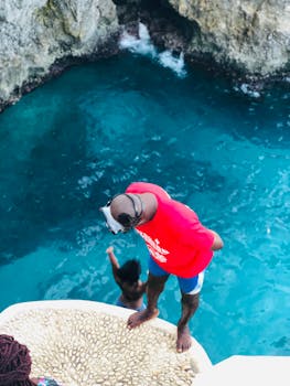 Man Standing On Rock Looking Down by Calandra