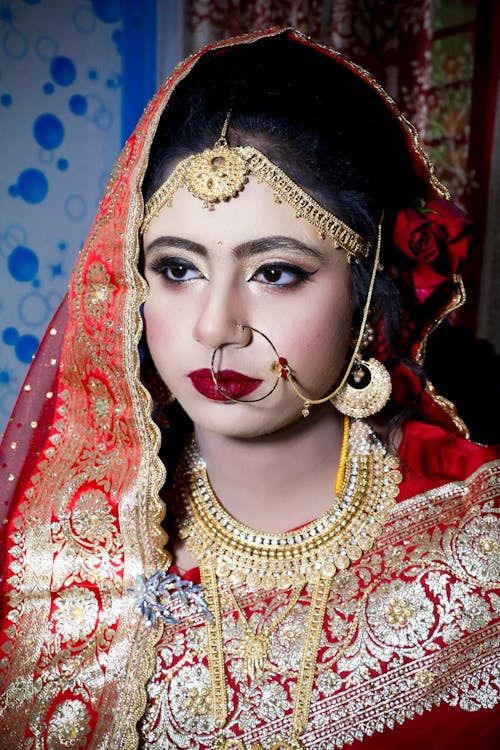 Portrait of Woman in Traditional Clothing and with Golden Jewelry