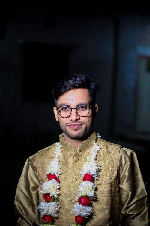 Free Portrait of a smiling man in traditional clothing with garland. Stock Photo