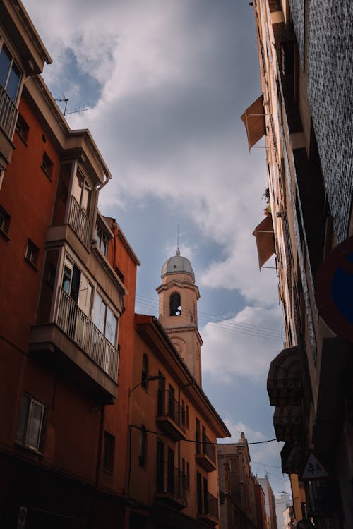 Church Tower behind Buildings Walls