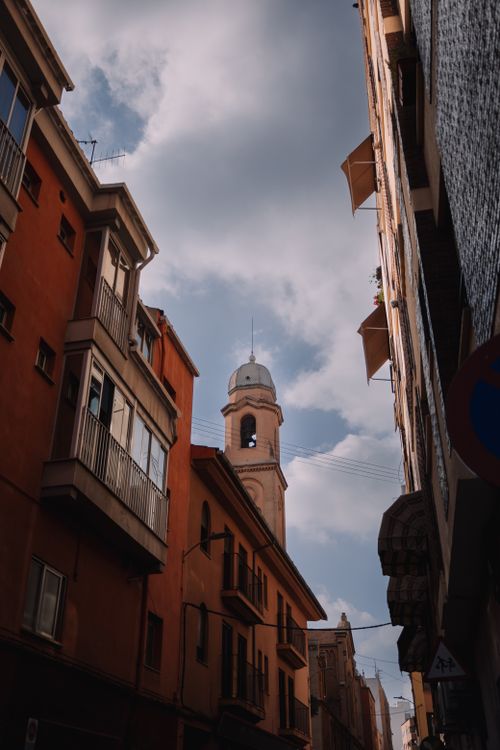 Free Low angle view of a classic church tower in the urban streets of Valencia, Spain. Stock Photo