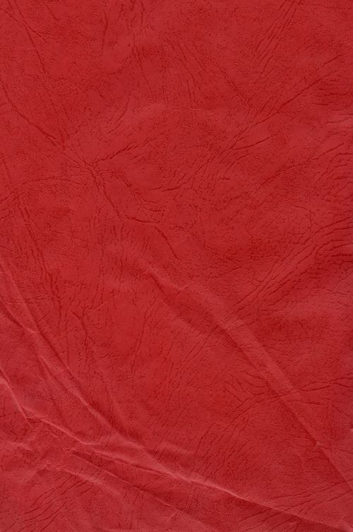 Free Close-up of a vibrant red fabric texture with detailed creases, perfect for design projects. Stock Photo