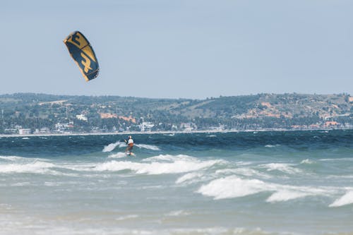 Man Kitesurfing on Sea Coast