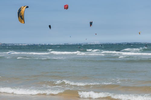 Kites over Kitesurfers on Sea Shore