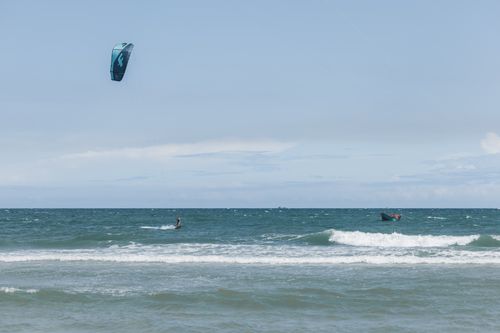 Free A thrilling kitesurfing scene captures an adventurous spirit on a bright sunny day by the sea. Stock Photo