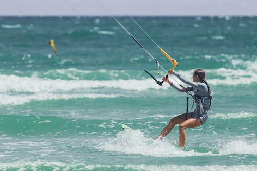 Woman Kitesurfing on Sea Shore