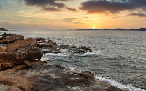 Sunset over Rocks on Sea Shore