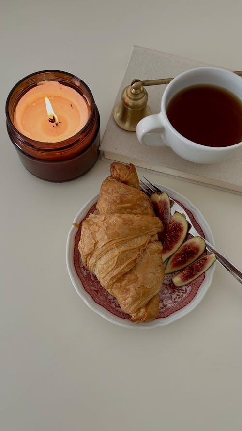 Croissant, Beverage in Cup and Wax Candle