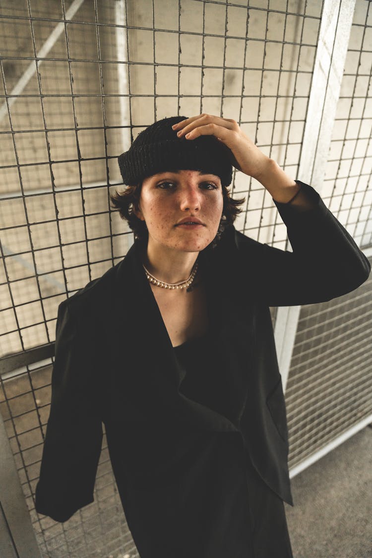 Woman Wearing Black Coat On A Parking Lot 