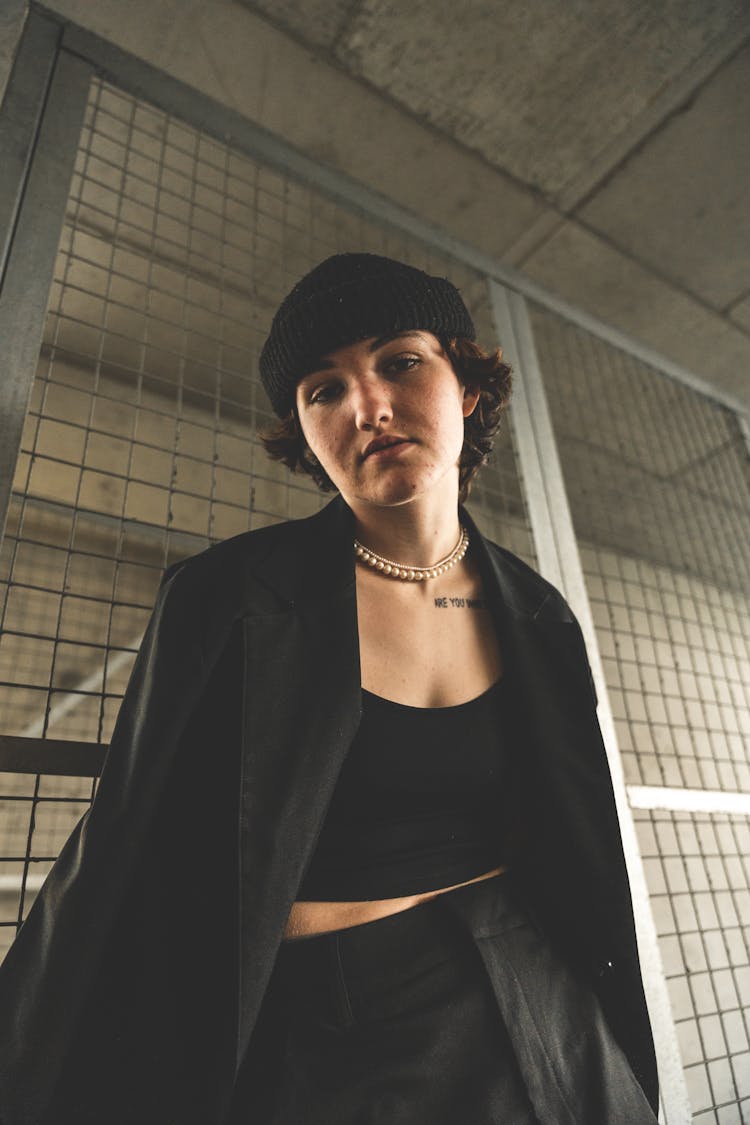 Woman Wearing Black Coat On A Parking Lot 