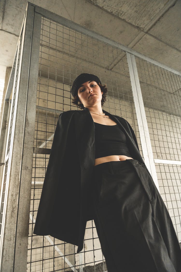 Woman Wearing Black Coat On A Parking Lot 