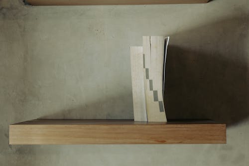 Close-up of Books Standing on a Wooden Shelf