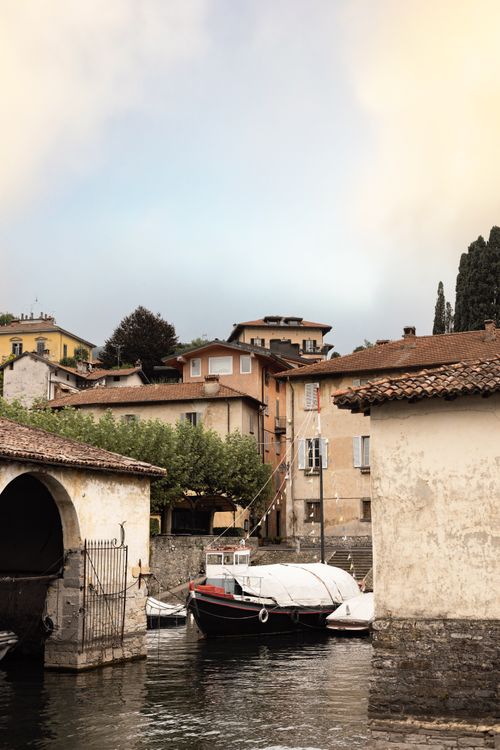 Free Scenic view of a quaint canal surrounded by historical buildings in Italy. Stock Photo