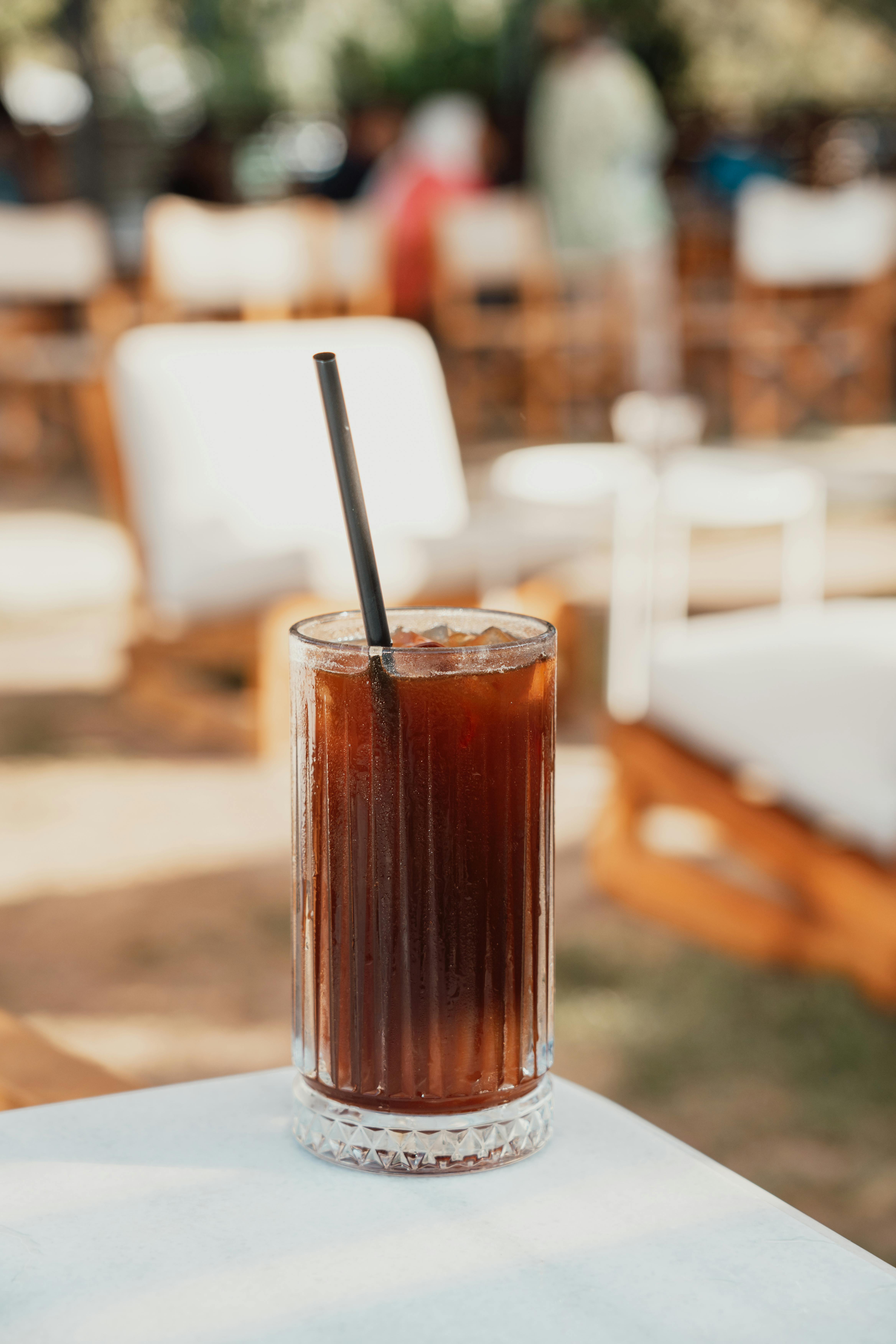 Iced coffee drink on glass jar with straw. Stock Photo by Civil