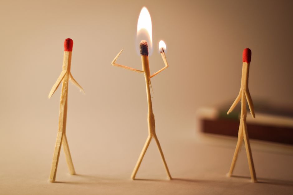 Artistic matchstick figures arranged with flames showcasing creativity and craftsmanship.