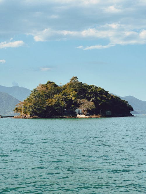 A Small Island and View of Mountains in the Background 