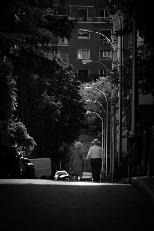 Back View of Elderly People Walking on the Sidewalk