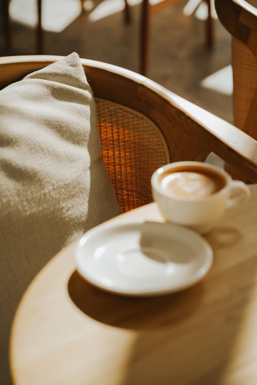 Free Cozy café setting in Ankara with cappuccino in soft sunlight, perfect for relaxation. Stock Photo