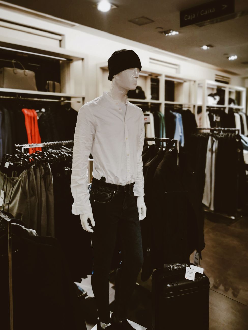 Mannequin dressed in stylish outfit at a contemporary clothing store, showcasing latest fashion trends.