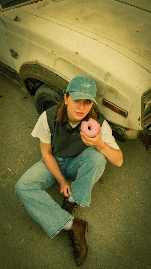 Casual Style Woman Eating Donut with Pink Icing