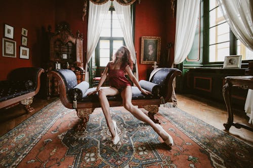 Woman in a Red Lingerie Sitting in an Antique Room
