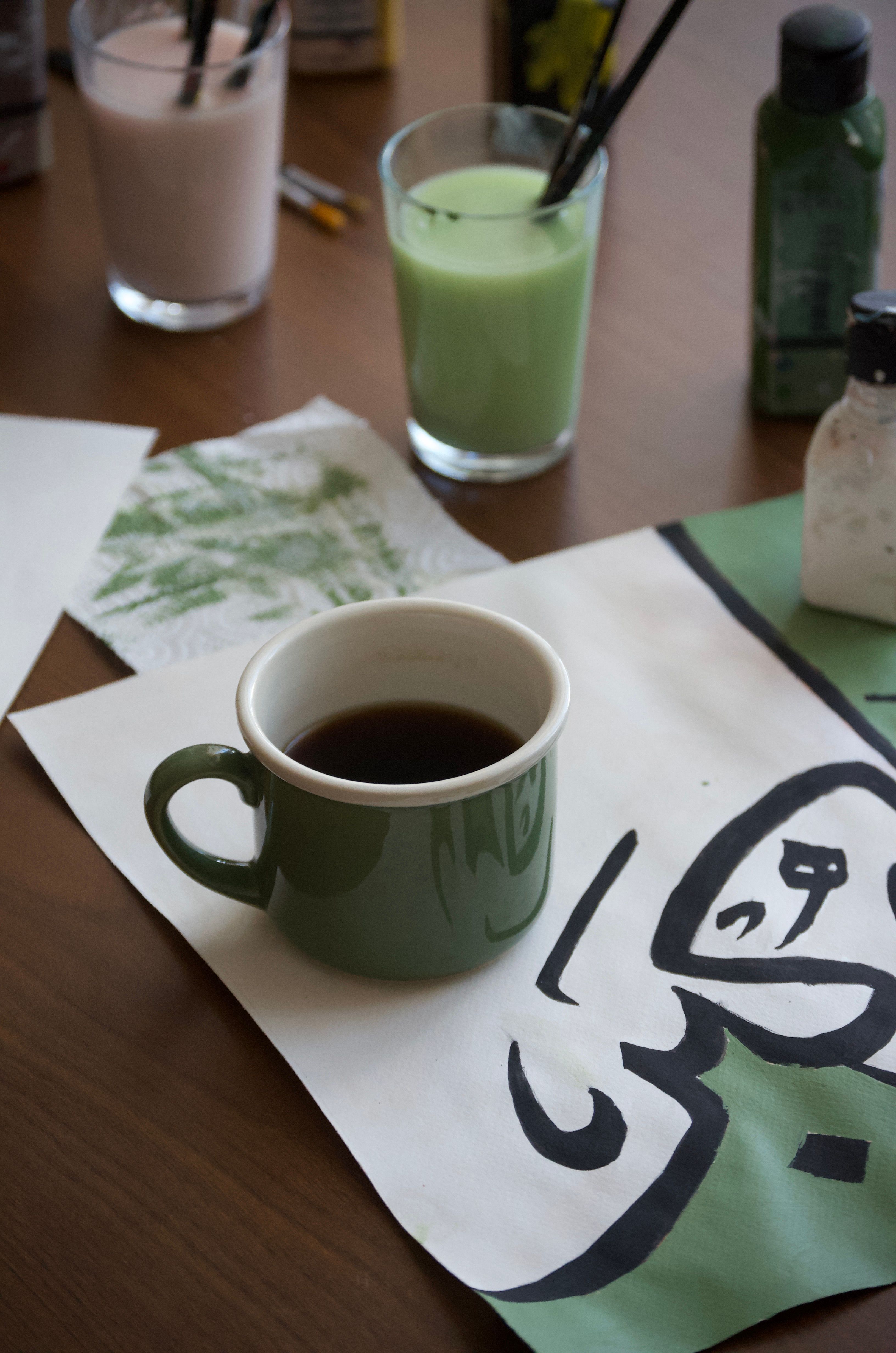 A cozy setup with a coffee mug amid art supplies, perfect for creative inspiration.