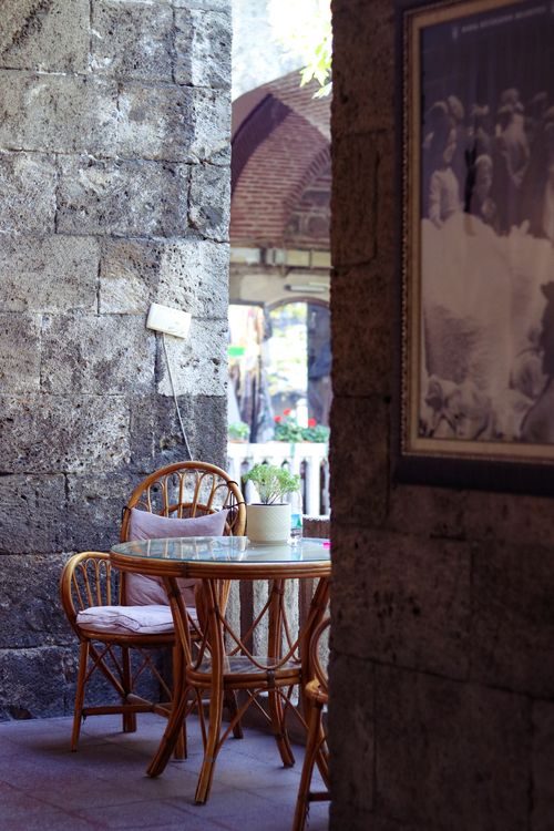 Free Charming outdoor café scene with wicker furniture in historic Bursa, Türkiye. Stock Photo