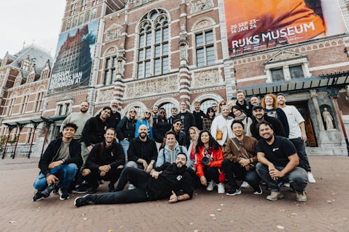 People Posing for a Group Photo in front of Rijksmuseum in Amsterdam 