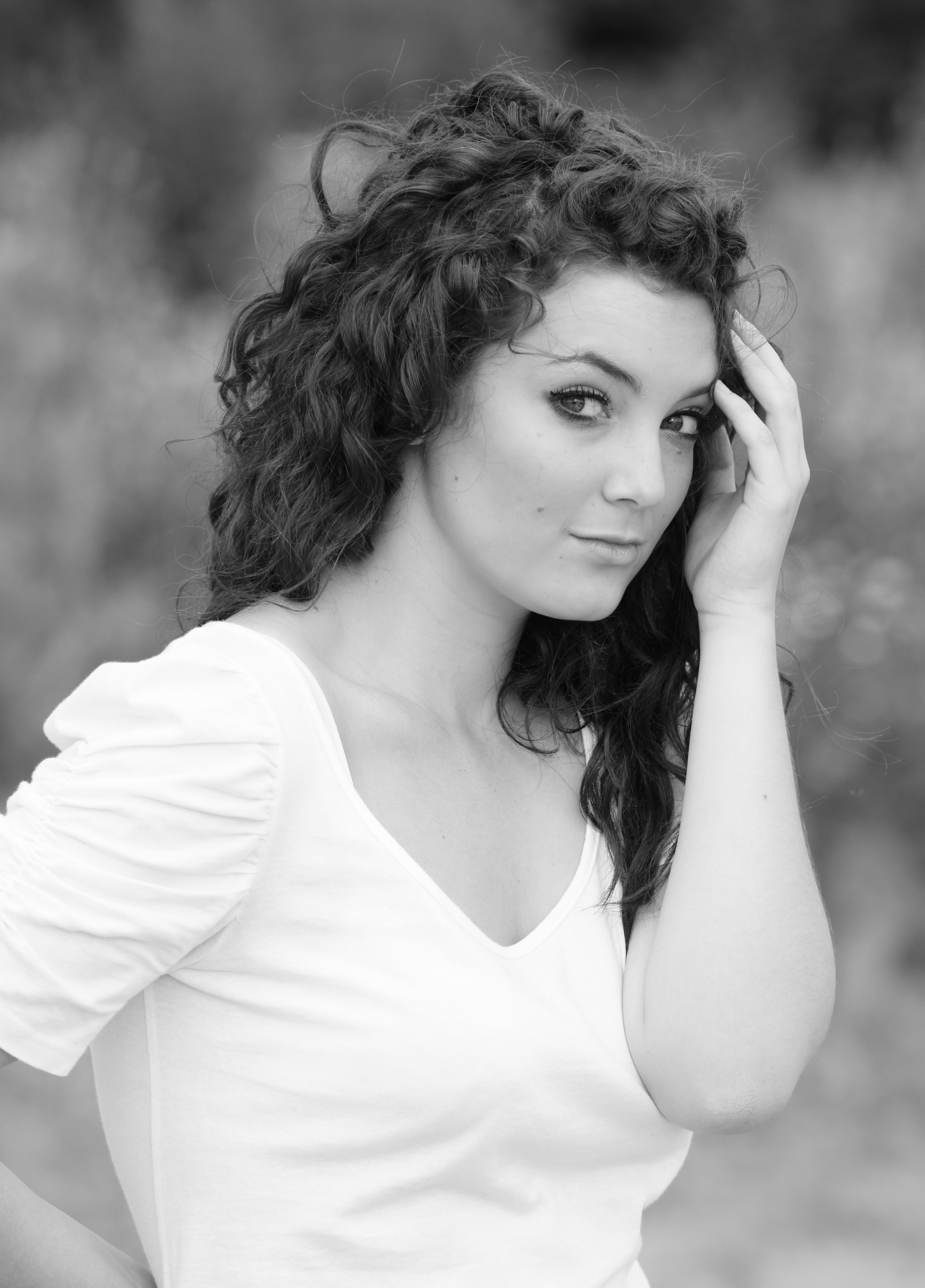 A woman with curly hair posing for a black and white photo · Free Stock ...