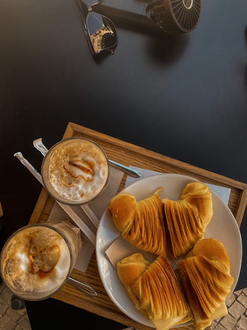 Top View of Iced Coffees and Pastry Served on a Tray in a Cafe