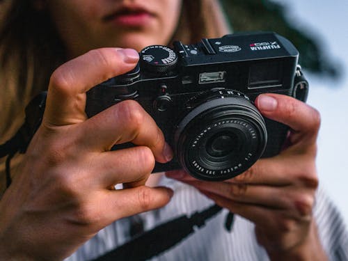 Free Close-Up Photo of Woman Holding Camera Stock Photo