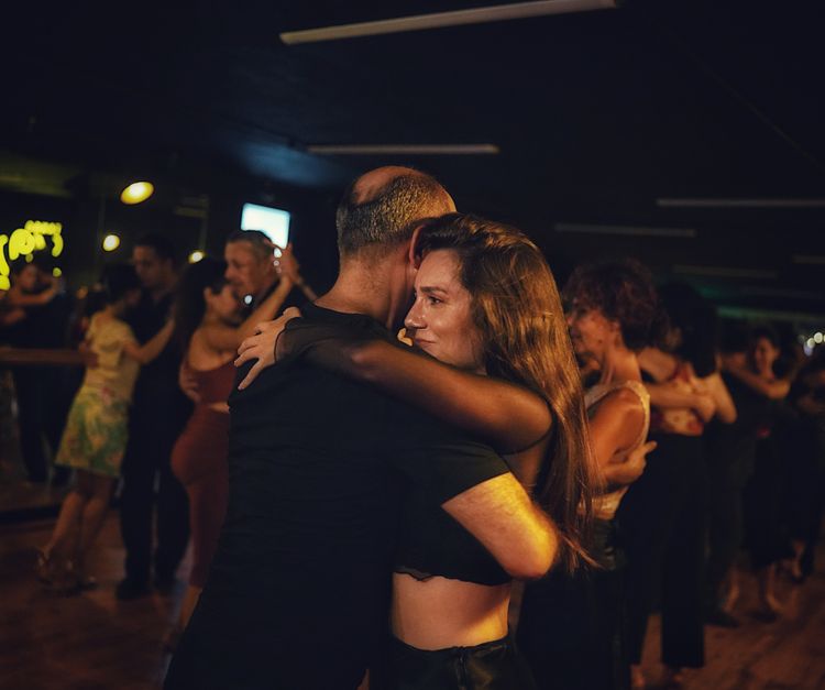 Couple in an abrazo during a milonga