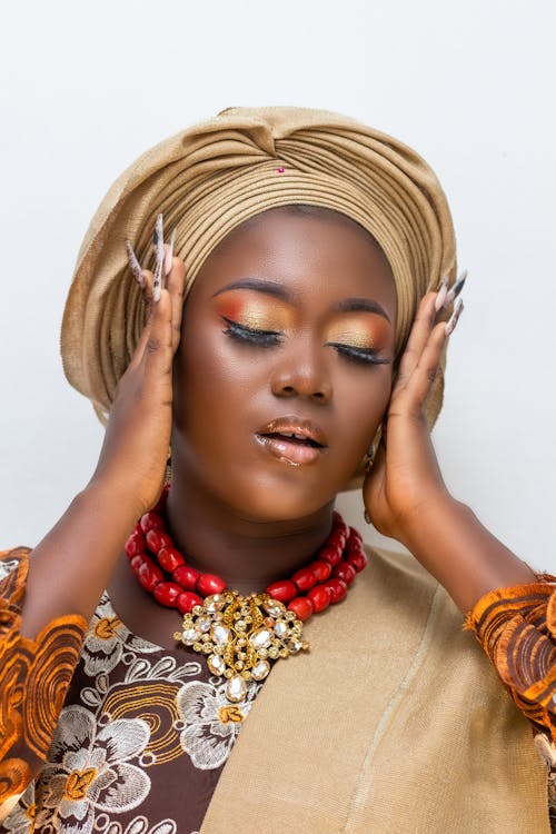 Portrait of a Young Woman Wearing a Turban and Glamour Makeup 
