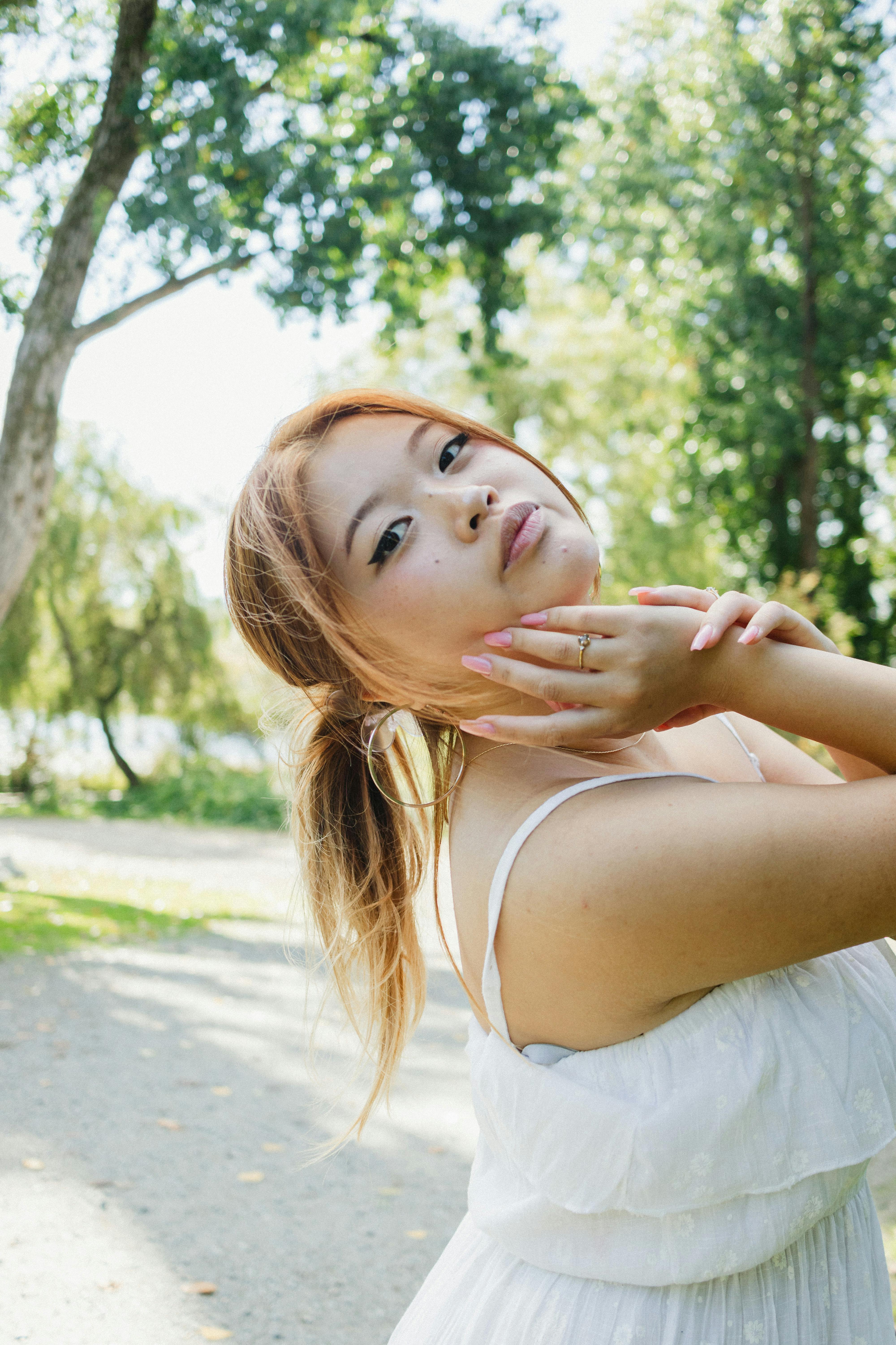 Stylish fashion photography featuring a woman in a white dress outdoors, exuding elegance and grace.