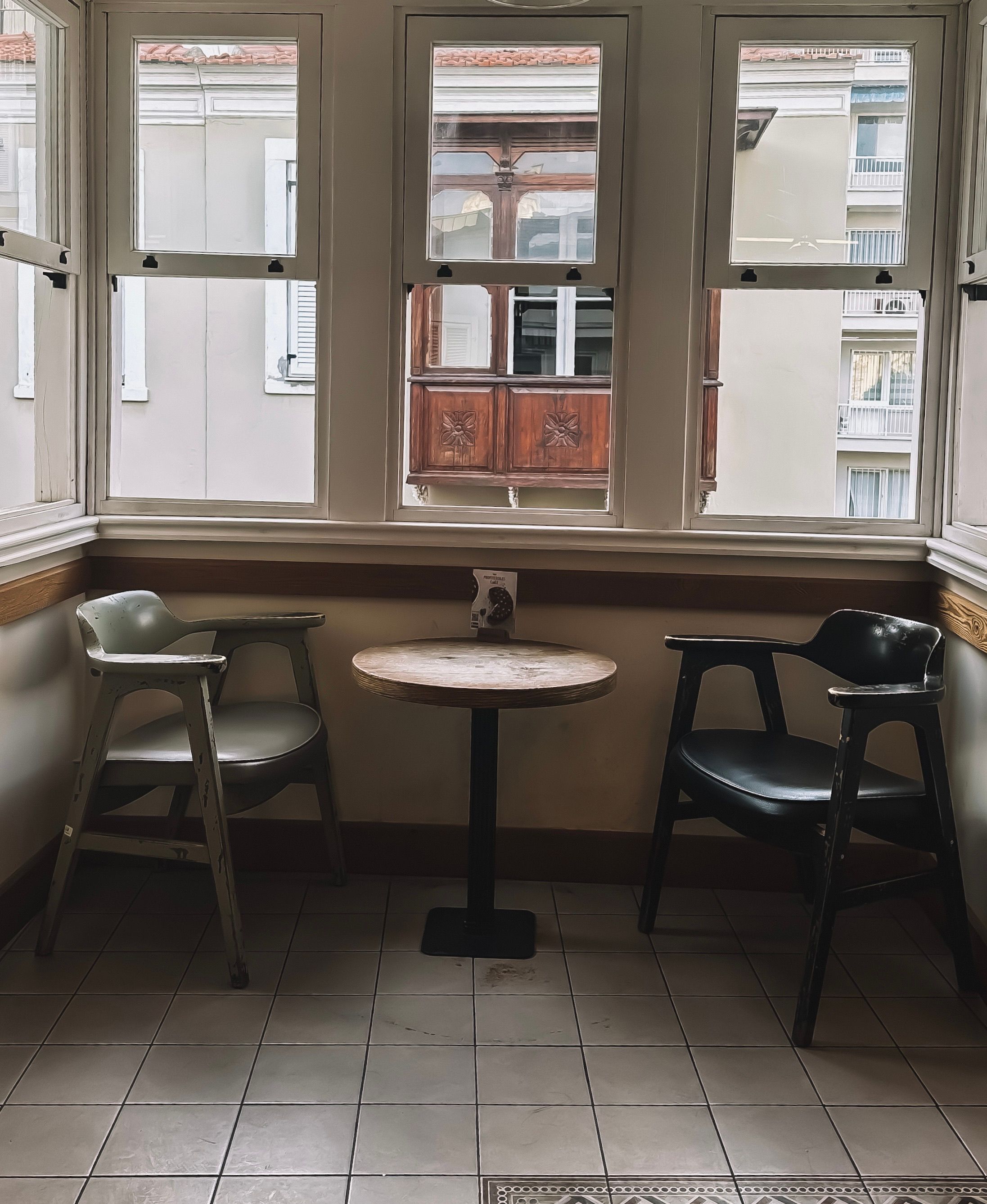 Two chairs and a table in front of a window · Free Stock Photo