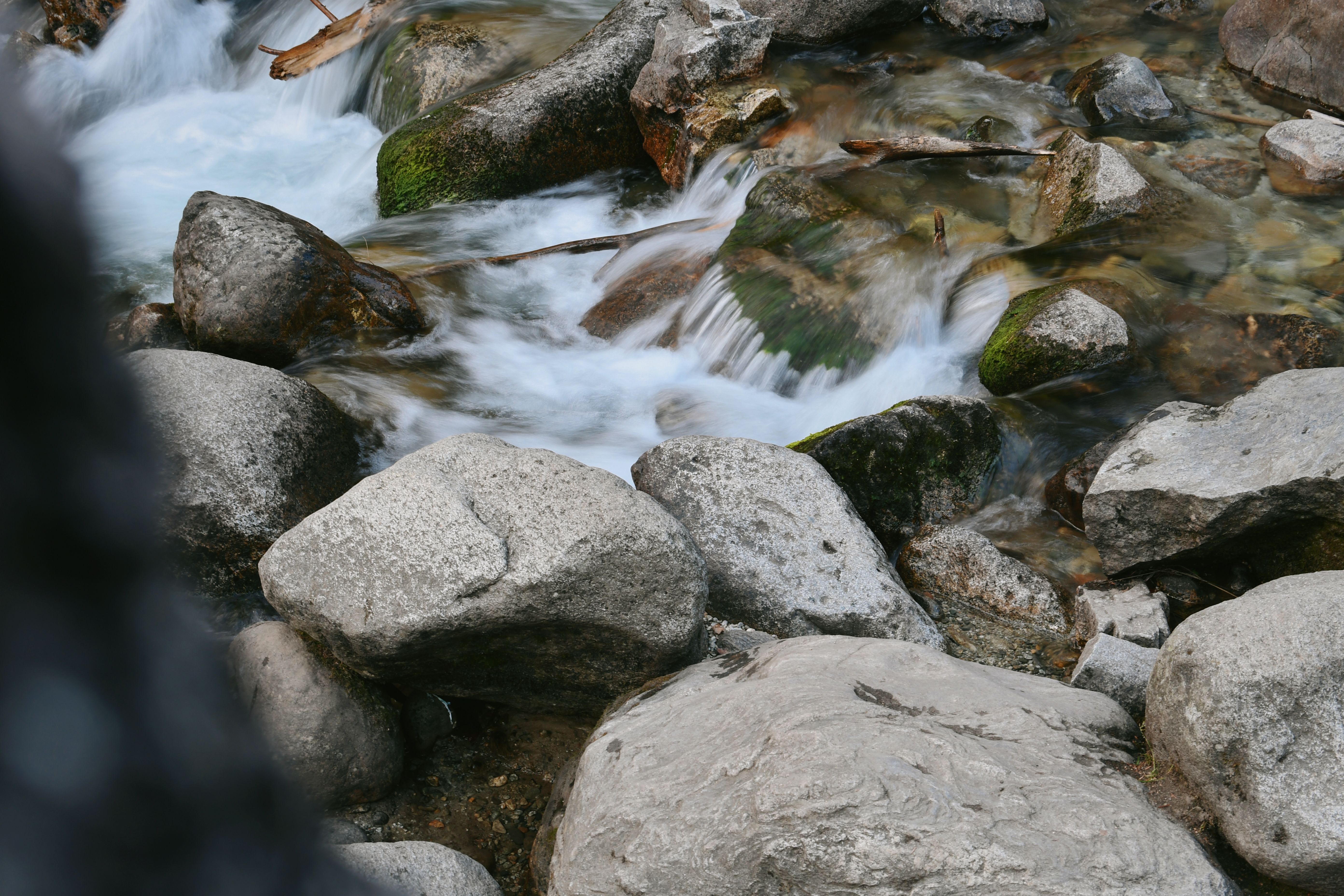 Stream Flowing between Rocks · Free Stock Photo