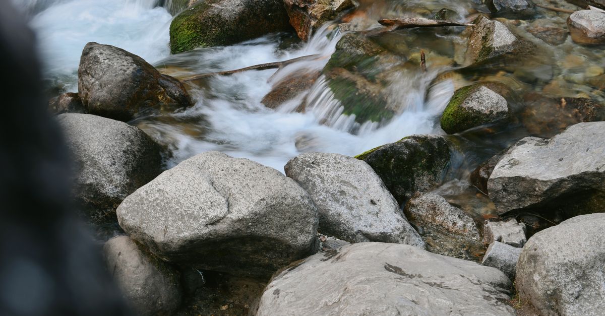 Stream Between Two Rocks Stream Flowing between Rocks · Free Stock Photo