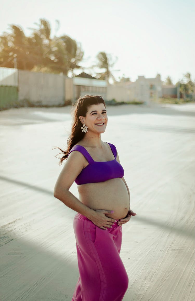 Happy Pregnant Woman In Pink Pants