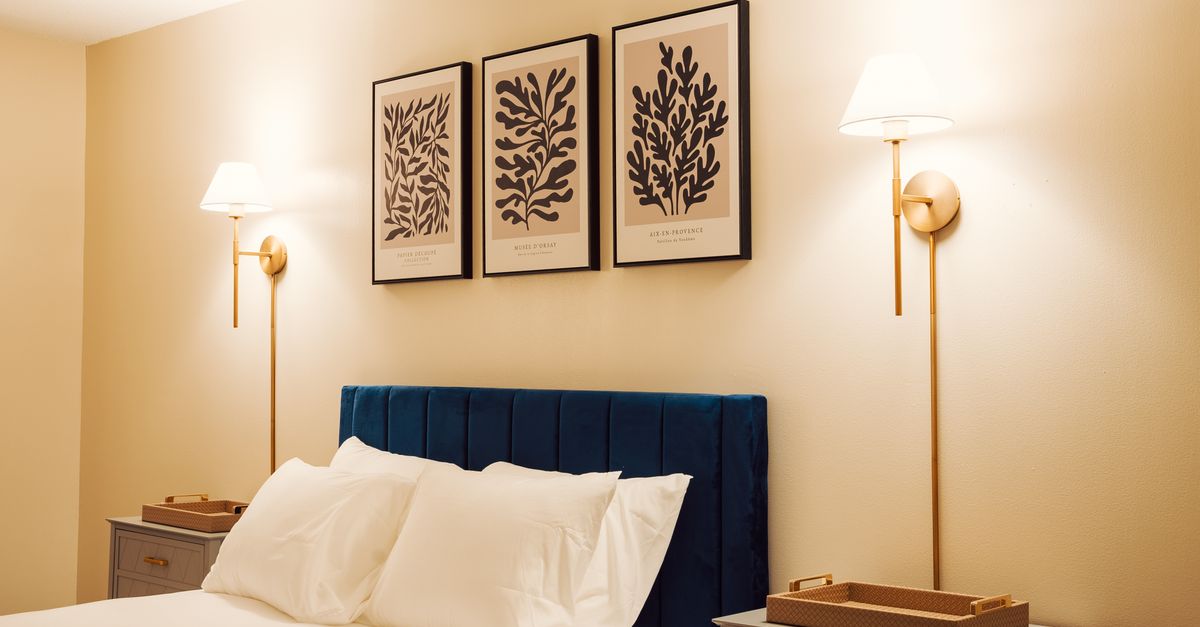 Stylish modern hotel room with elegant lighting and framed wall art.