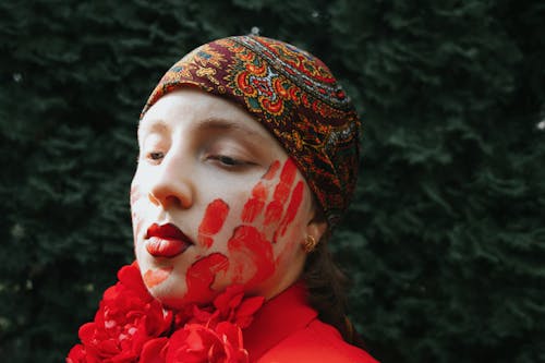 A Woman with a Red Hand Mark on her Face