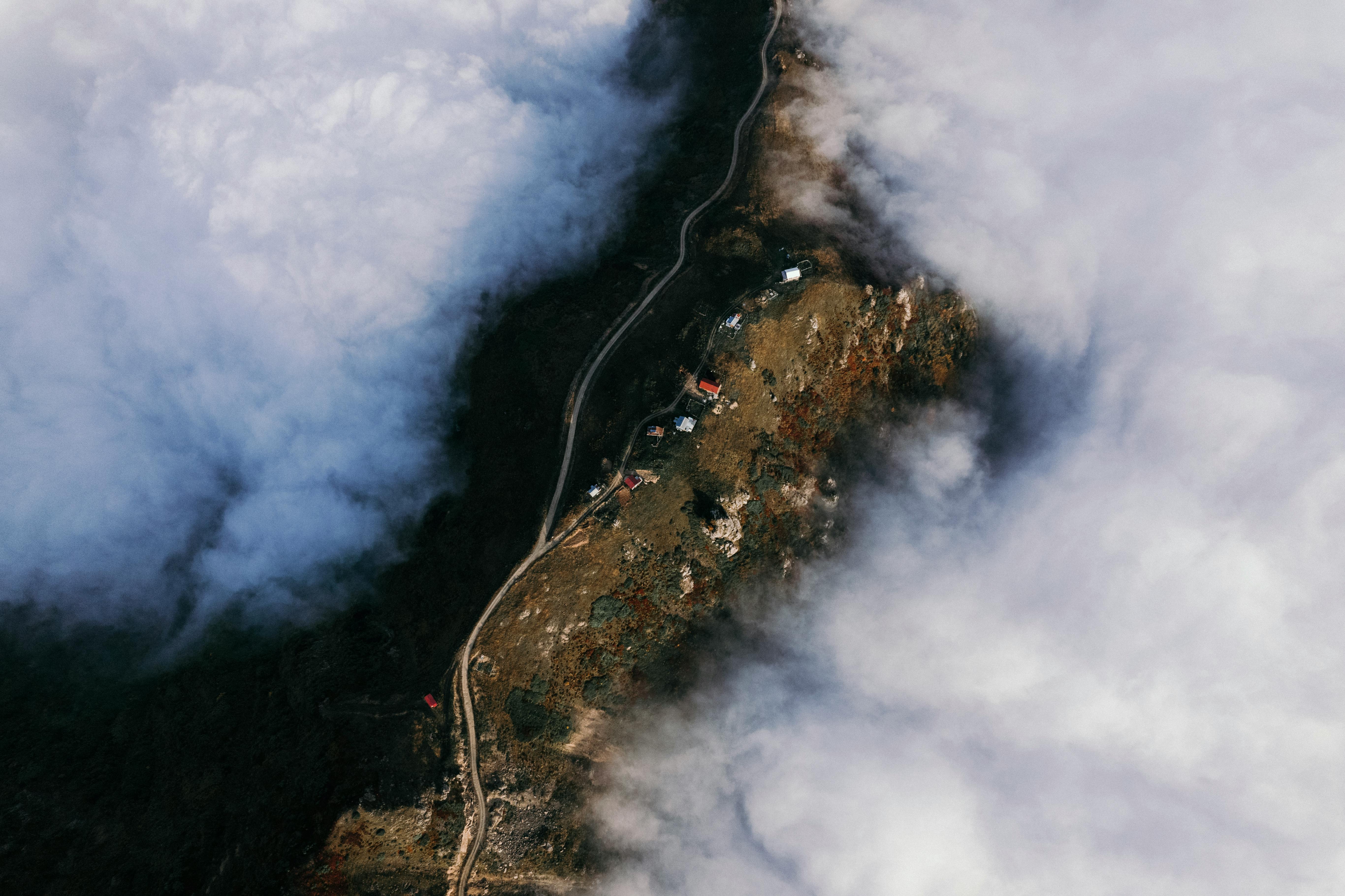 Stunning aerial view of a rural area in Artvin, Türkiye, enveloped in clouds.