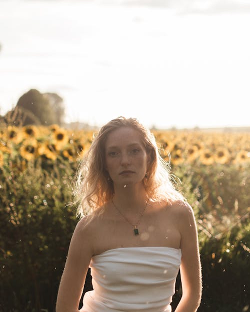 Blonde Model with Sunflowers Field behind