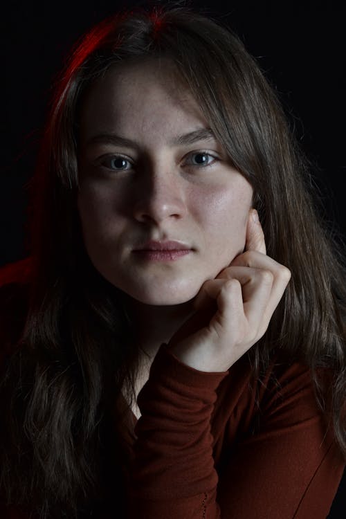 Studio Portrait of a Young Woman on Dark Background 