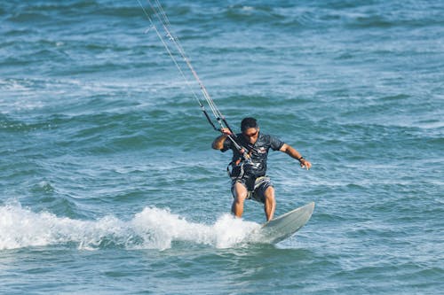 Man Kitesurfing in Sea