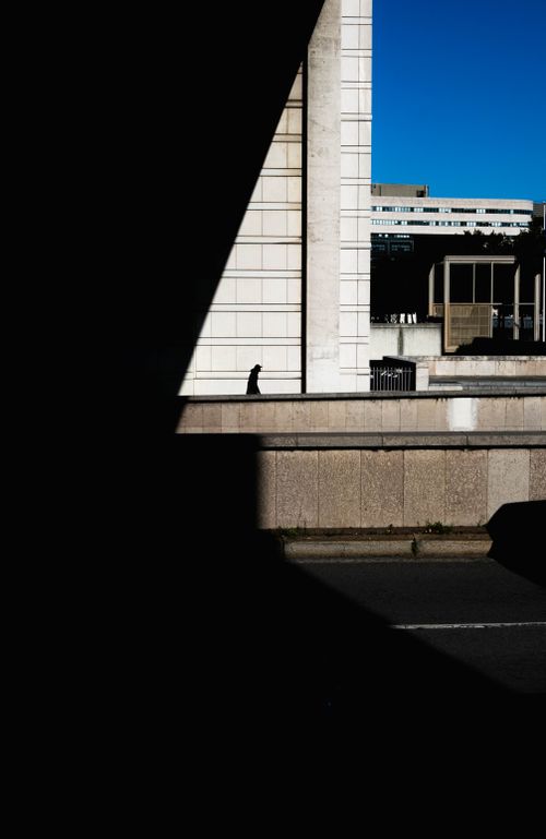 Free Dramatic urban scene with stark shadows and a bright blue sky. Stock Photo