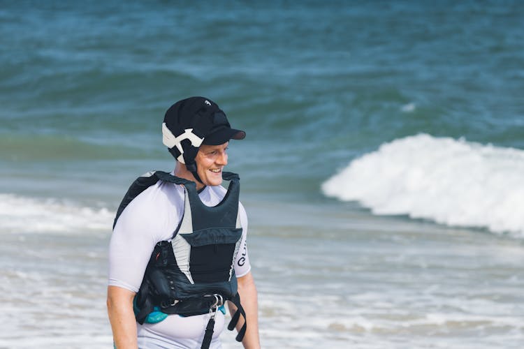 Smiling Man In Professional Paddleboard Uniform On Beach